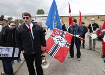 Iført blå bomberjakke ses Jesper Krogh Sørensen her bag ved nazilederen Jonni Hansen, bærende på en hagekorsfane, ved DNSB's Rudolf Hess-march i Kolding i 2007. Foto: Redox.
